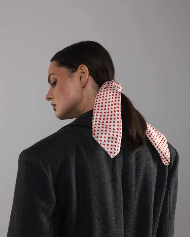 The Ambasador coat with a red and cream printed scarf