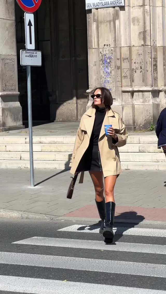 The Kopi coat in motion on a sunlit Kraków street